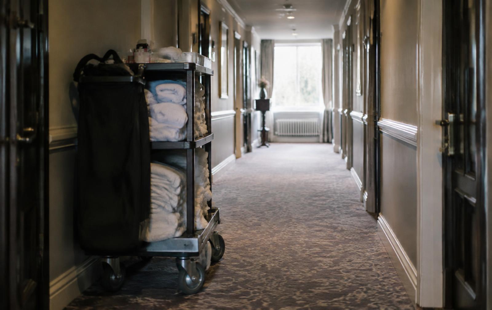 A housekeeping trolley parked in a quiet hotel corridor