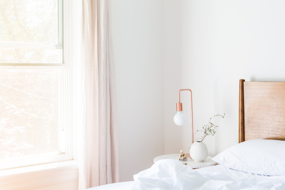 A freshly made bed in a guest room, ready for the next arrival